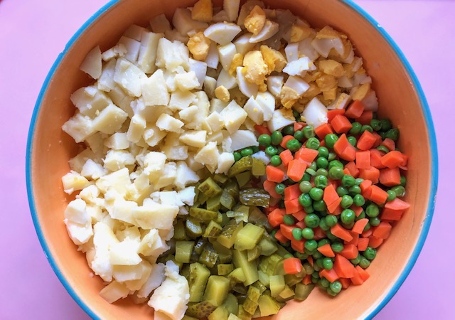 cooked potatoes and eggs, peas and corn, pickles