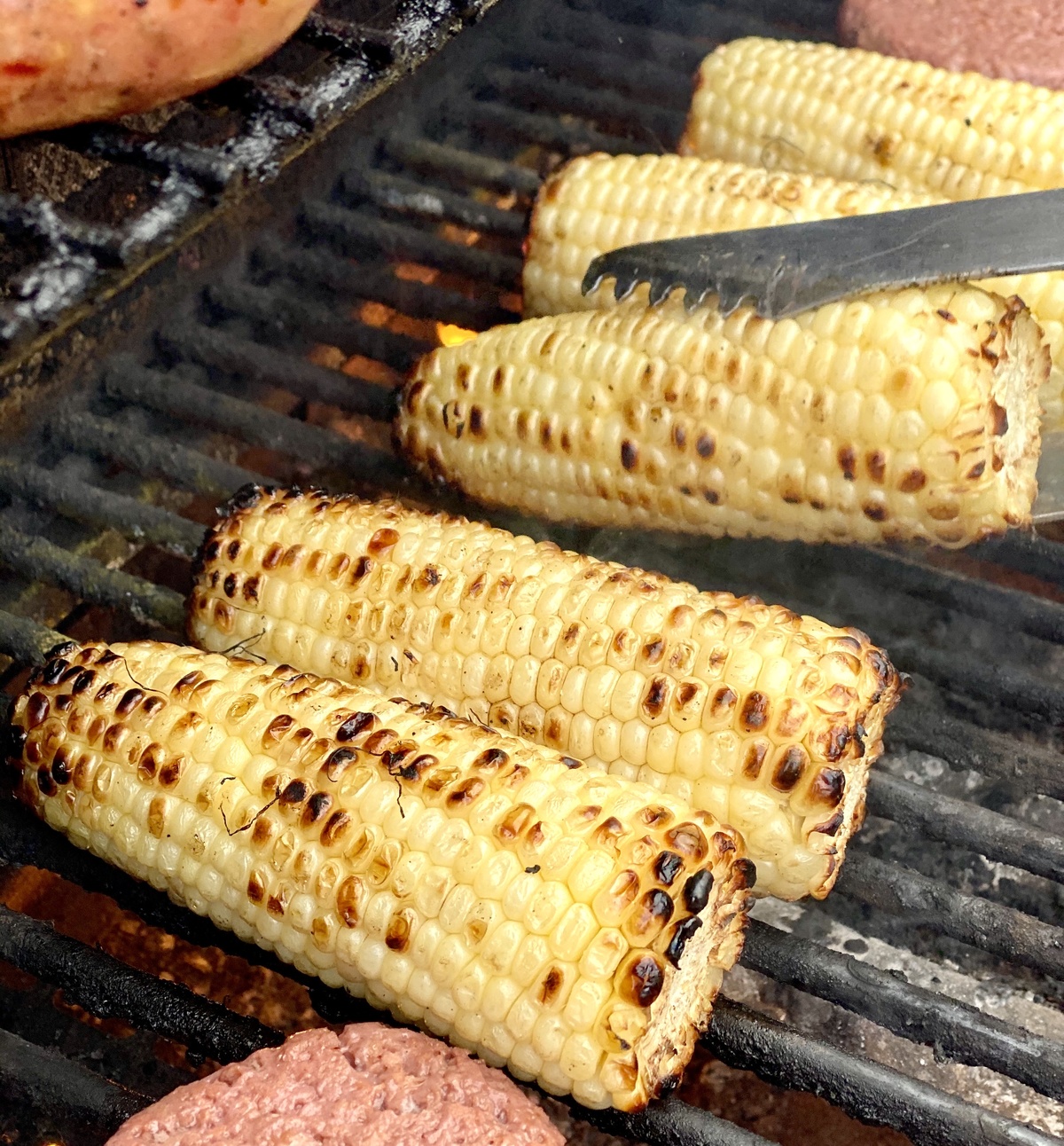 Persian Street Corn cooking on barbecue BBQ grill