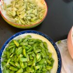 shelling fresh fava beans for Persian rice