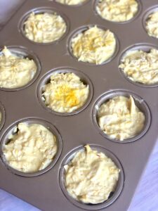 stacking and layering tahchin tahcheen ingredients into a non-stick muffin tray or tin